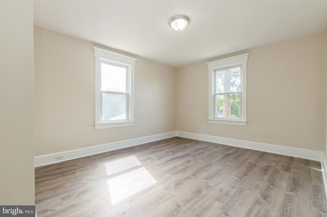 empty room with light hardwood / wood-style flooring