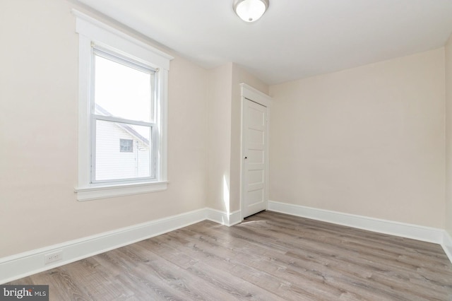 spare room featuring light hardwood / wood-style flooring and a wealth of natural light