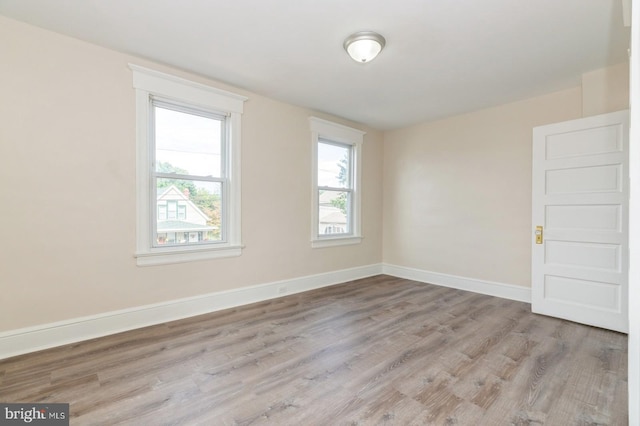 spare room featuring light hardwood / wood-style flooring