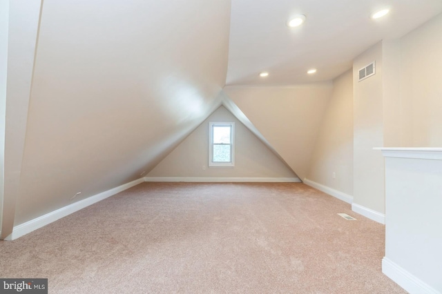 bonus room featuring light carpet and vaulted ceiling