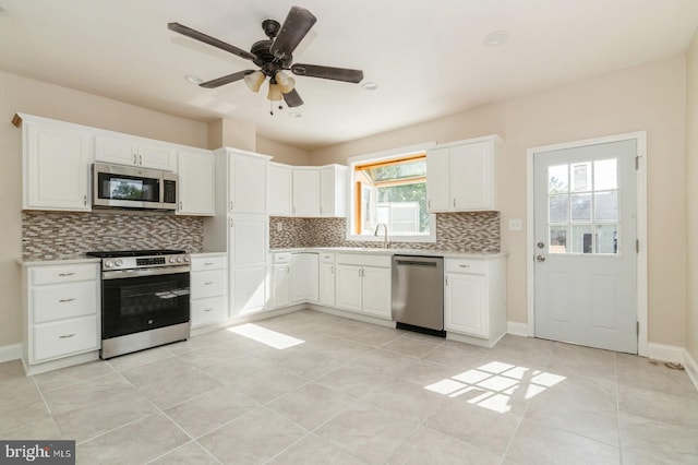 kitchen featuring white cabinets, appliances with stainless steel finishes, and sink