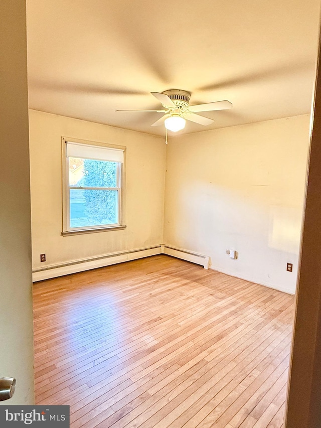 empty room with a ceiling fan and hardwood / wood-style floors