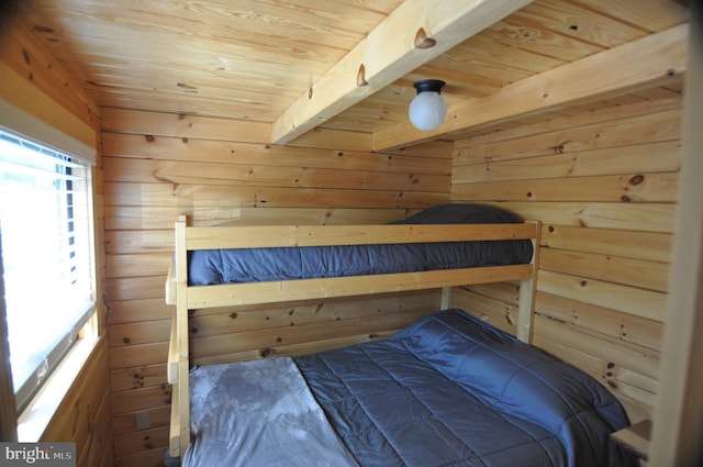 bedroom featuring wooden ceiling, beamed ceiling, wooden walls, and a sauna