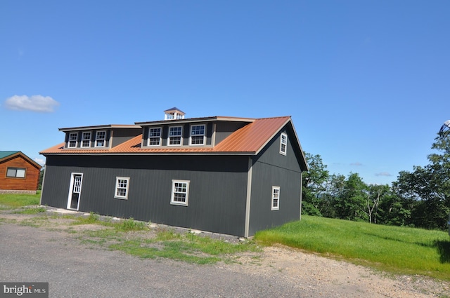 view of side of home with metal roof