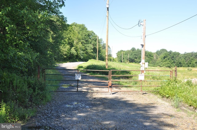 view of gate with a rural view