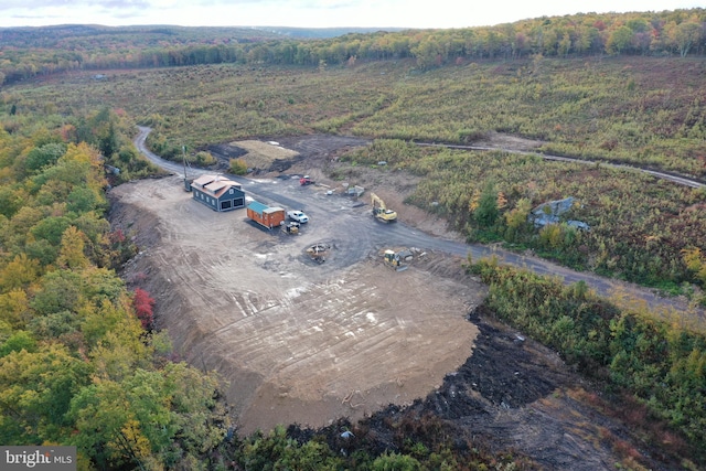 aerial view featuring a forest view and a rural view