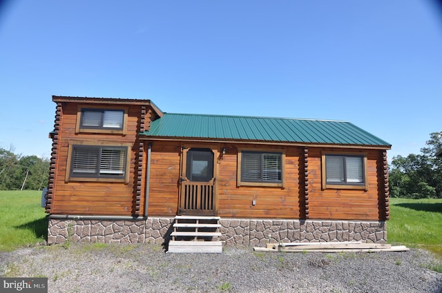 cabin with metal roof and log exterior