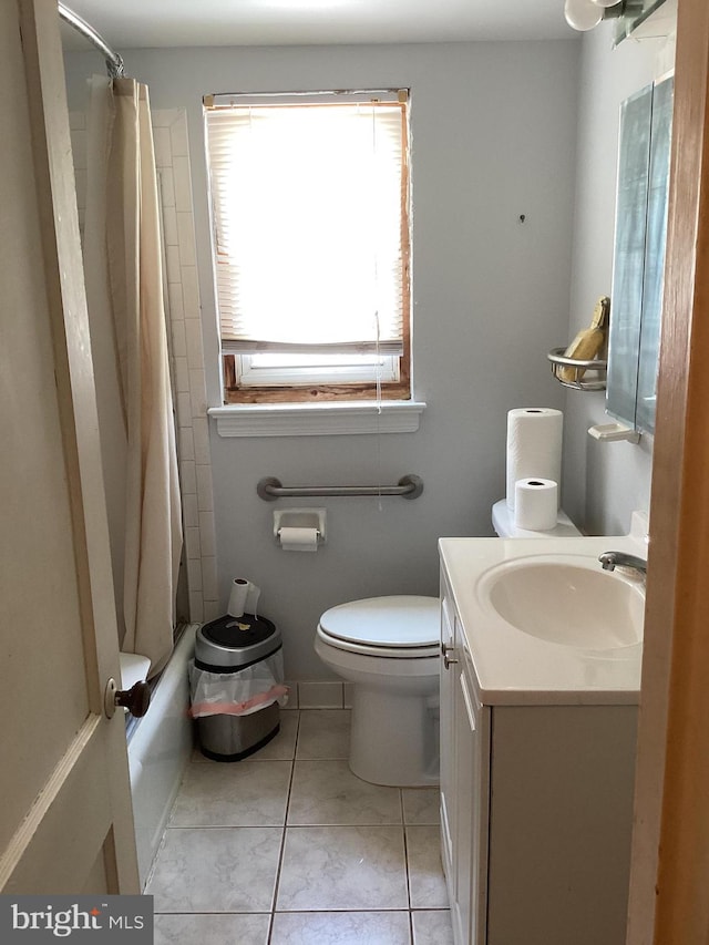 full bathroom with tile patterned floors, shower / tub combo with curtain, vanity, and toilet