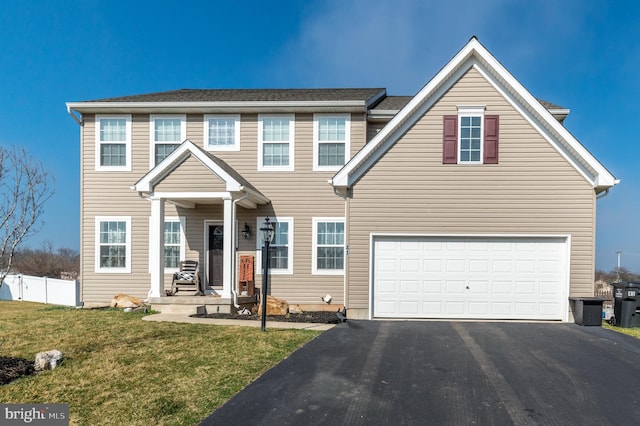 view of front of property with a front yard and a garage