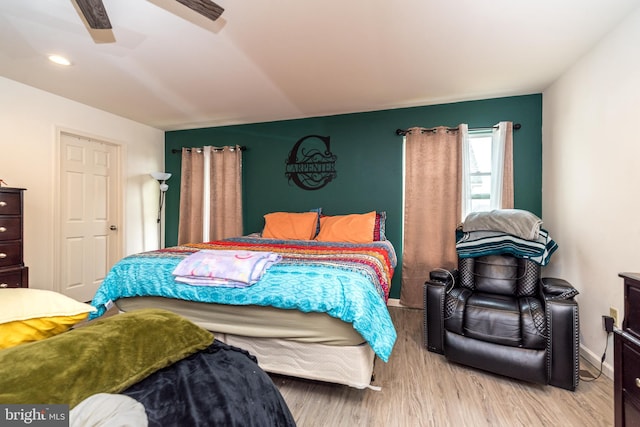 bedroom featuring light wood-type flooring and ceiling fan