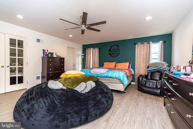 bedroom featuring ceiling fan, light wood-type flooring, and french doors