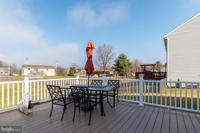 wooden deck with a lawn