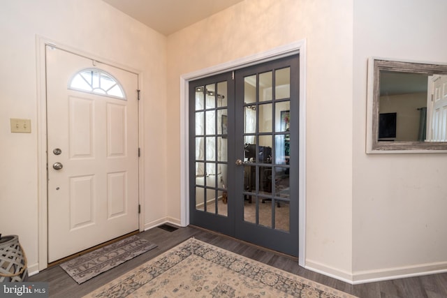 entryway featuring french doors and dark wood-type flooring