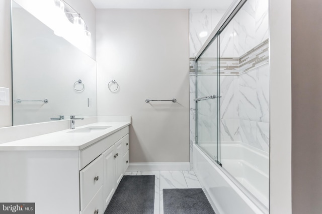 bathroom featuring enclosed tub / shower combo and vanity