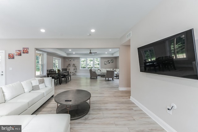 living room featuring ceiling fan and light wood-type flooring