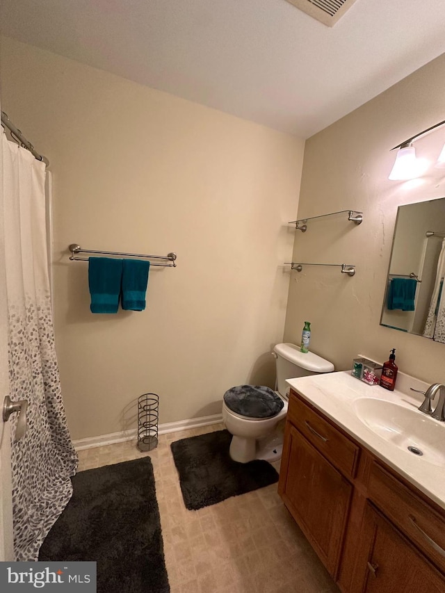 bathroom featuring vanity and toilet