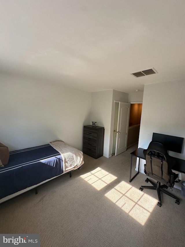 bedroom featuring light carpet