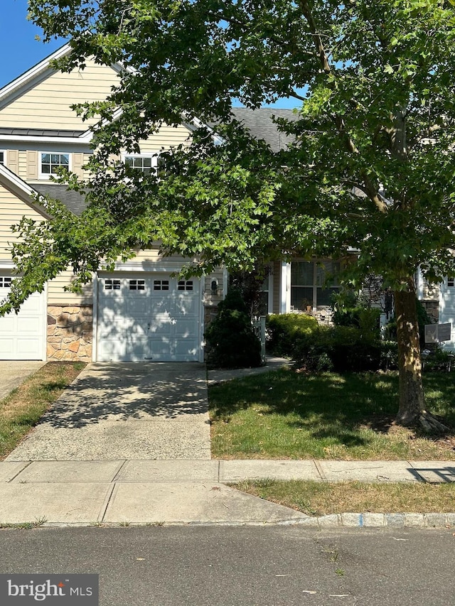 obstructed view of property with a garage