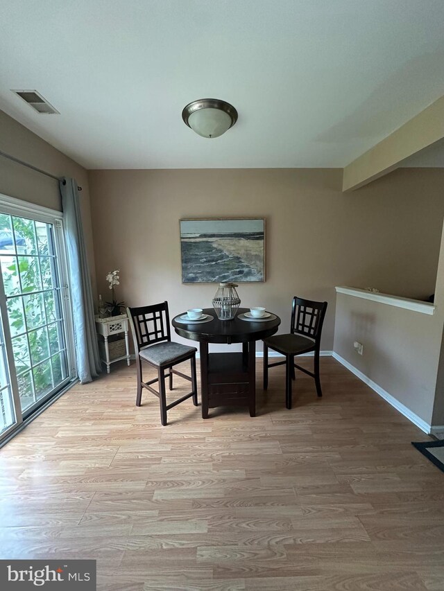 dining space with hardwood / wood-style flooring