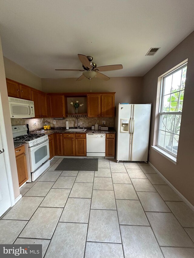 kitchen with ceiling fan, sink, tasteful backsplash, white appliances, and light tile patterned flooring