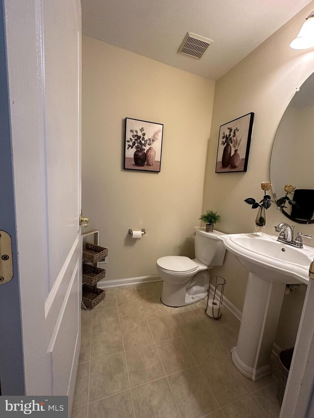 bathroom with tile patterned floors, toilet, and sink