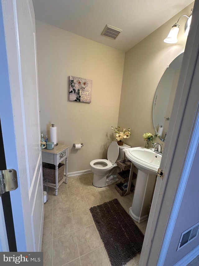 bathroom with tile patterned flooring and toilet