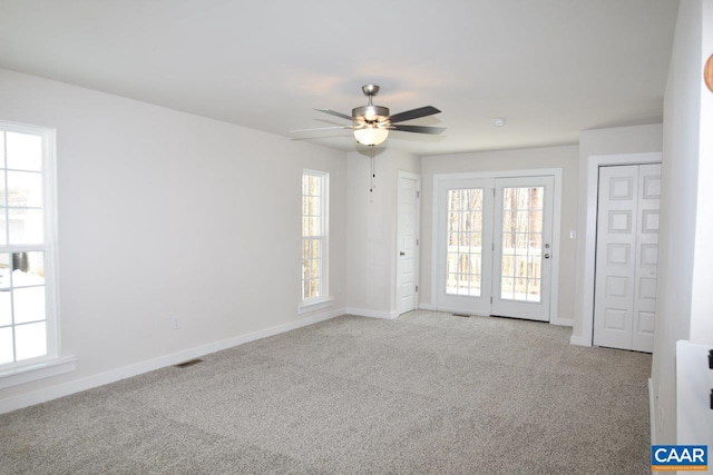 carpeted spare room with ceiling fan