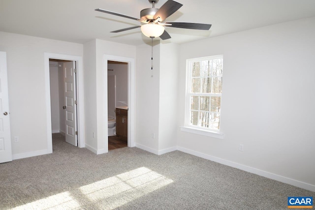 unfurnished bedroom featuring carpet floors, connected bathroom, and ceiling fan