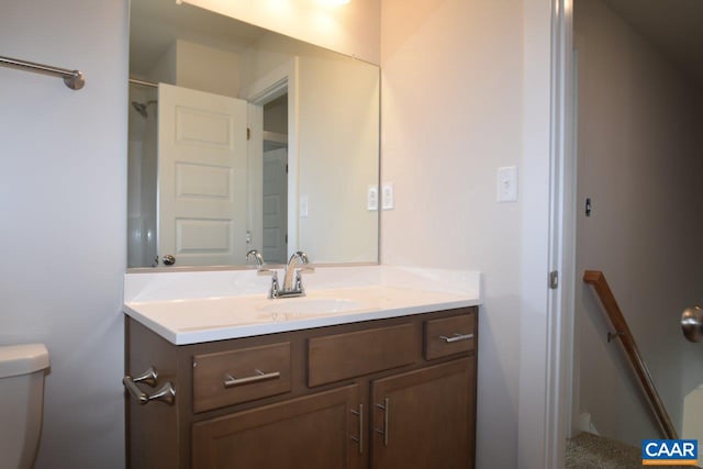 bathroom featuring vanity and toilet