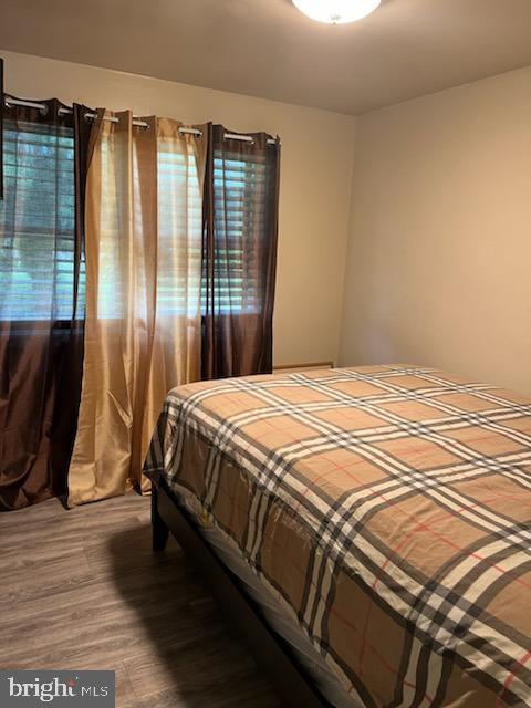 bedroom with wood-type flooring