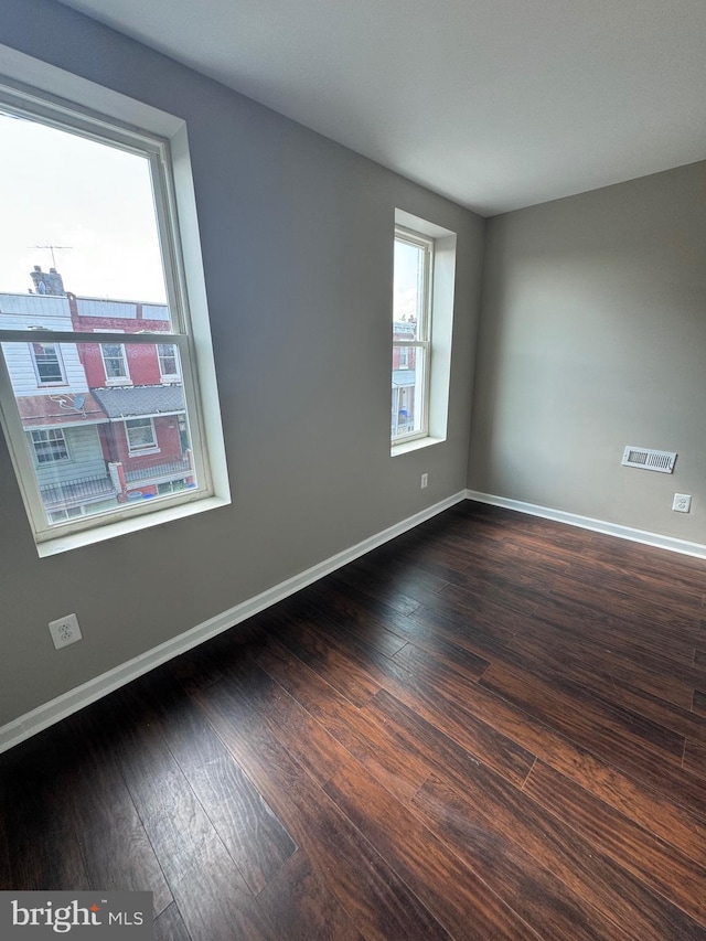 unfurnished room featuring dark wood-type flooring