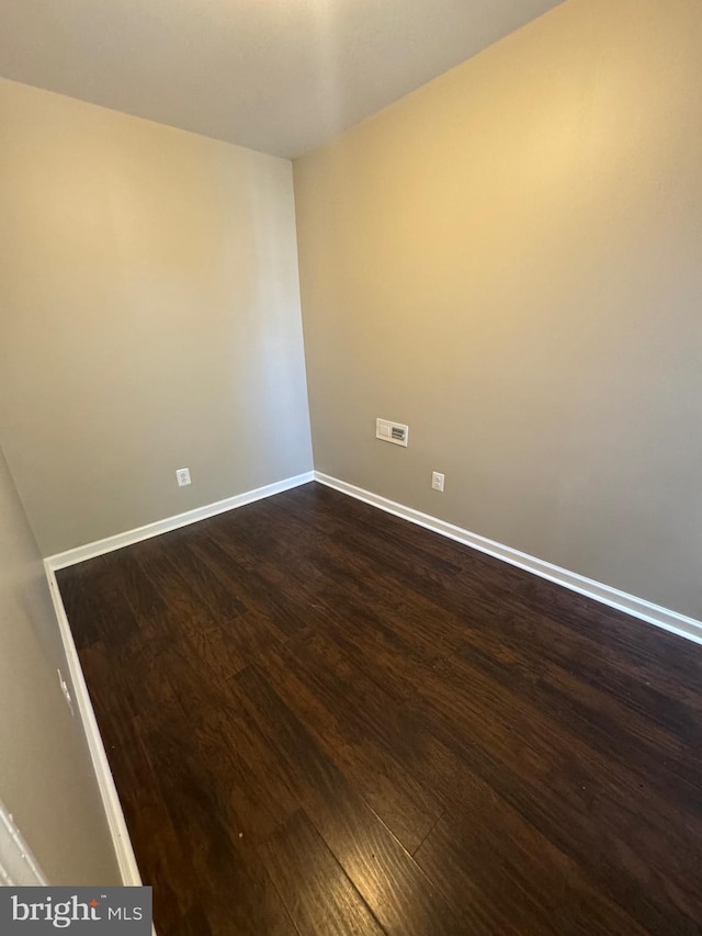 empty room featuring dark hardwood / wood-style flooring