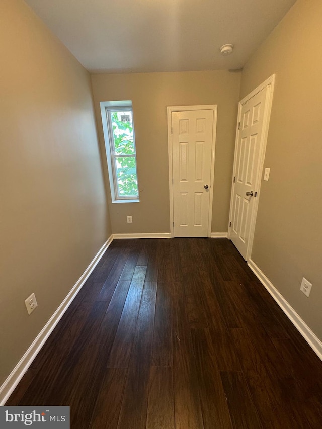 spare room featuring dark hardwood / wood-style floors