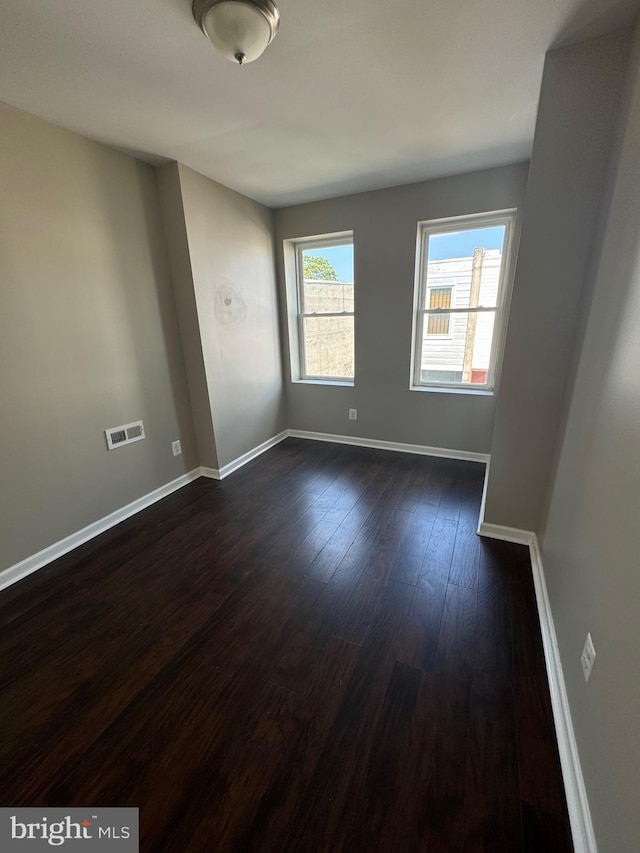 spare room featuring dark hardwood / wood-style flooring