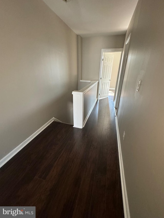 hallway with dark wood-type flooring