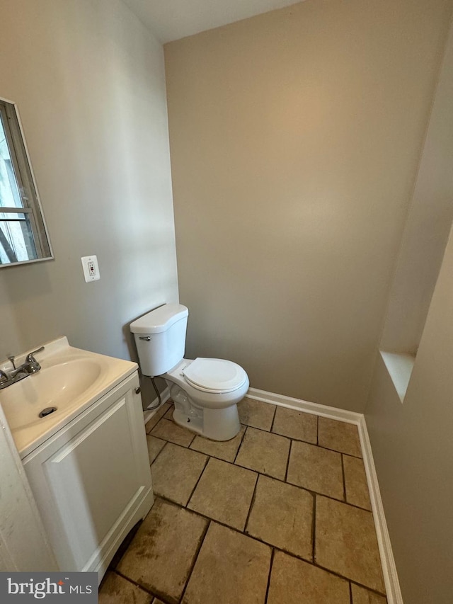 bathroom with toilet and vanity