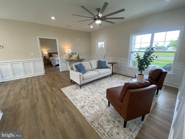 living room featuring ceiling fan and wood-type flooring