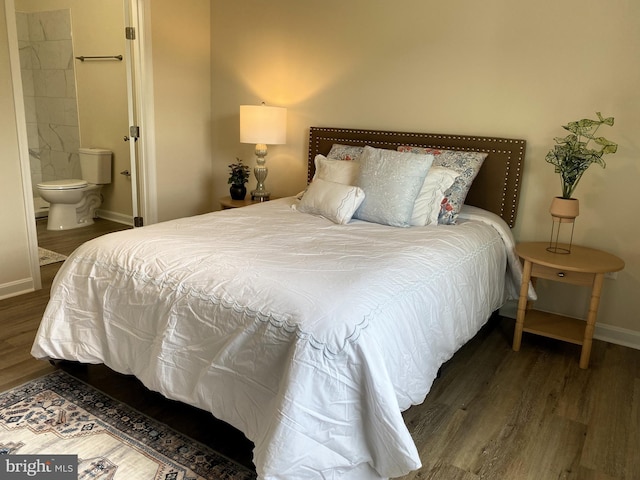 bedroom with dark hardwood / wood-style flooring and connected bathroom