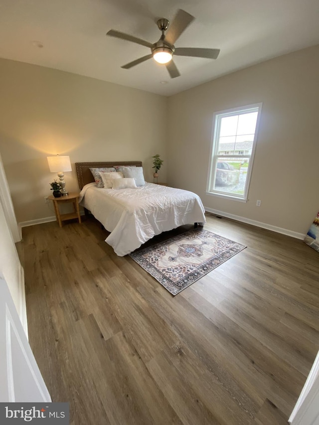 bedroom featuring hardwood / wood-style flooring and ceiling fan