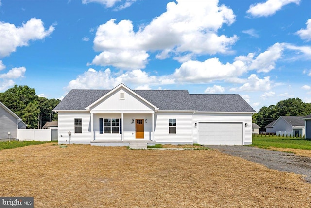 view of front of property with covered porch and a garage