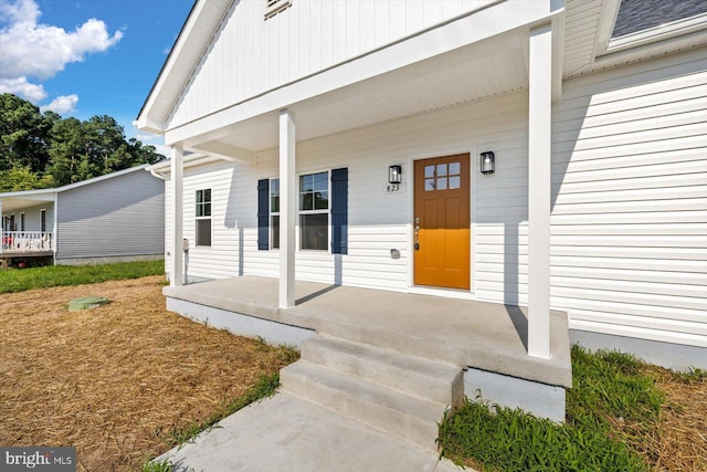 entrance to property featuring a porch