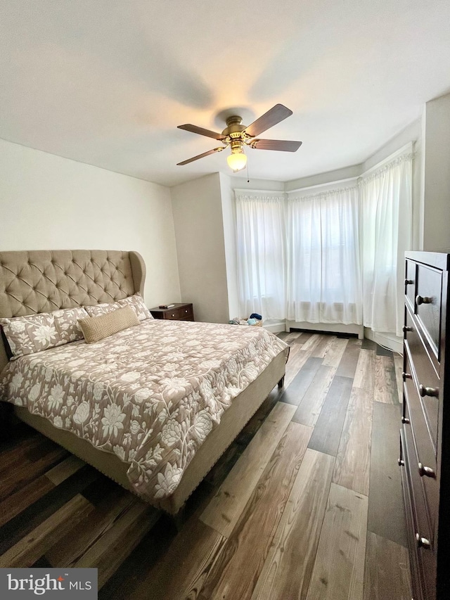 bedroom featuring wood-type flooring and ceiling fan