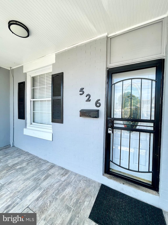 view of exterior entry with covered porch