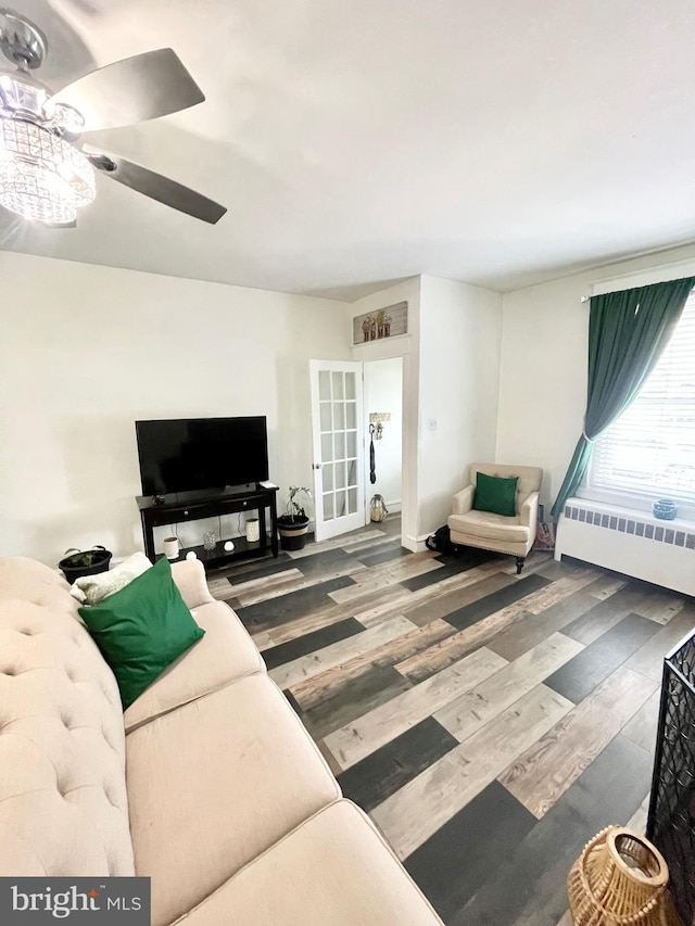 living room featuring ceiling fan, radiator heating unit, and hardwood / wood-style flooring