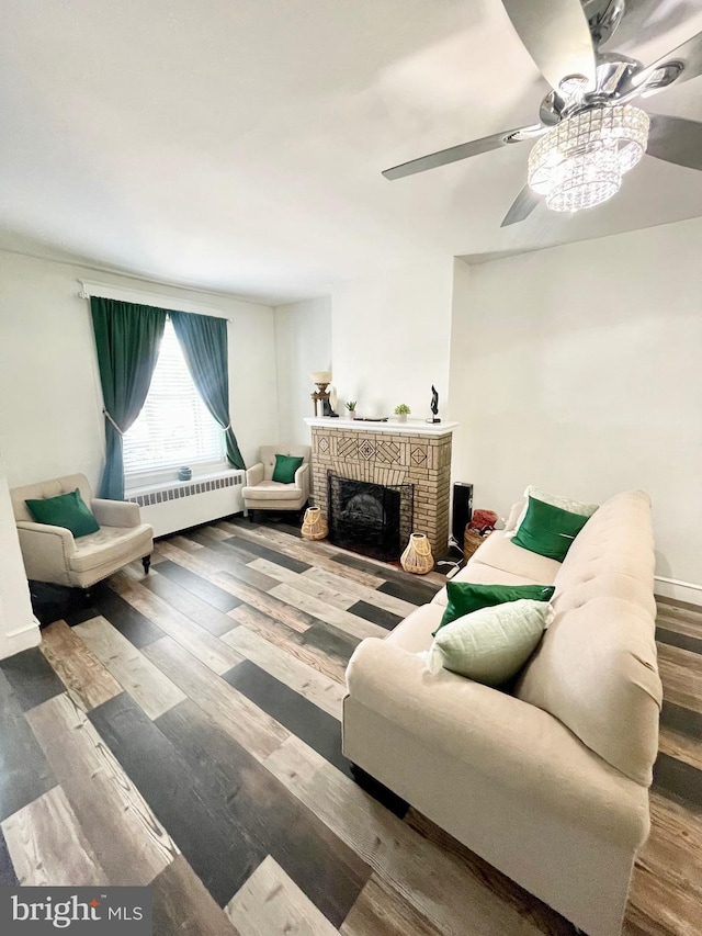 living room with radiator heating unit, ceiling fan, and wood-type flooring