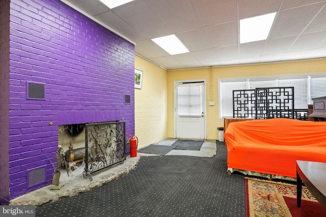 carpeted living room with a drop ceiling