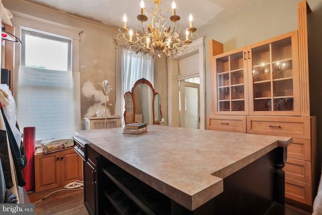 kitchen featuring a kitchen island, dark hardwood / wood-style flooring, hanging light fixtures, and a chandelier