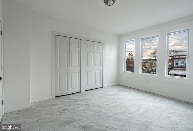 unfurnished bedroom with two closets