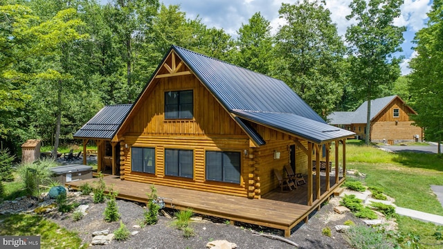 back of house featuring a yard and a wooden deck