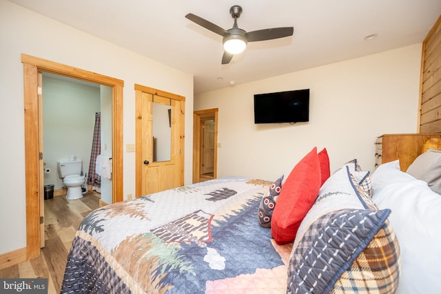 bedroom featuring ensuite bath, ceiling fan, and hardwood / wood-style flooring